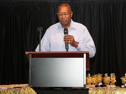 A speaker at the podium shares remarks with guests.