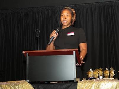 A speaker addresses guests from the podium.
