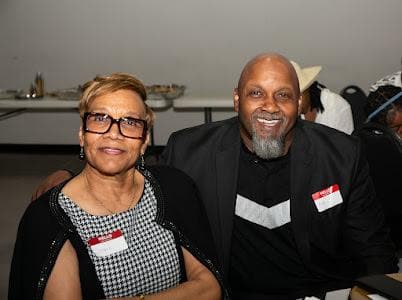 Two guests pose together at the celebration.