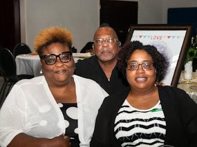 Three guests pose together at the celebration.