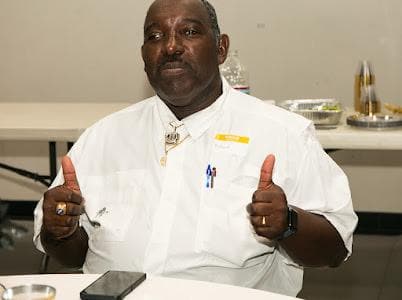 A guest gives two thumbs up at the celebration.