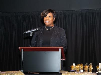 A speaker stands at the podium during the program.
