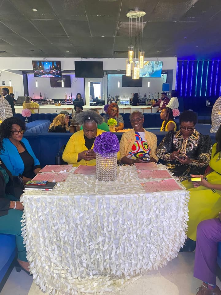 Guests seated at a decorated table at the award celebration.